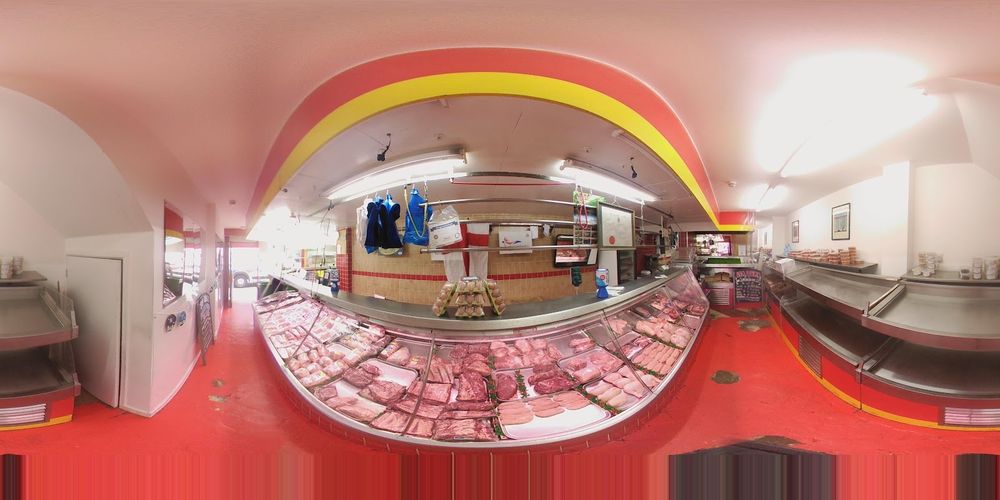 Inside Fresh Meat Market: the red-fronted display counter full of meat, with the serving area behind